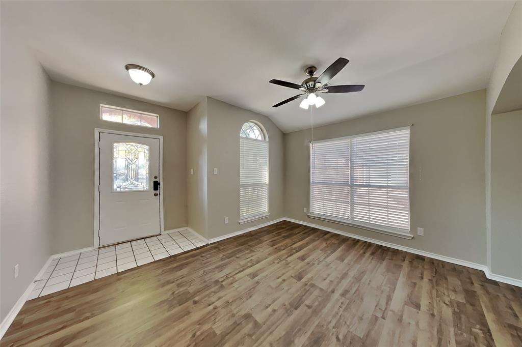 7709 Harbor Drive Rowlett, TX 75088 - Photo 15 of 19 a view of an empty room with a window and wooden floor