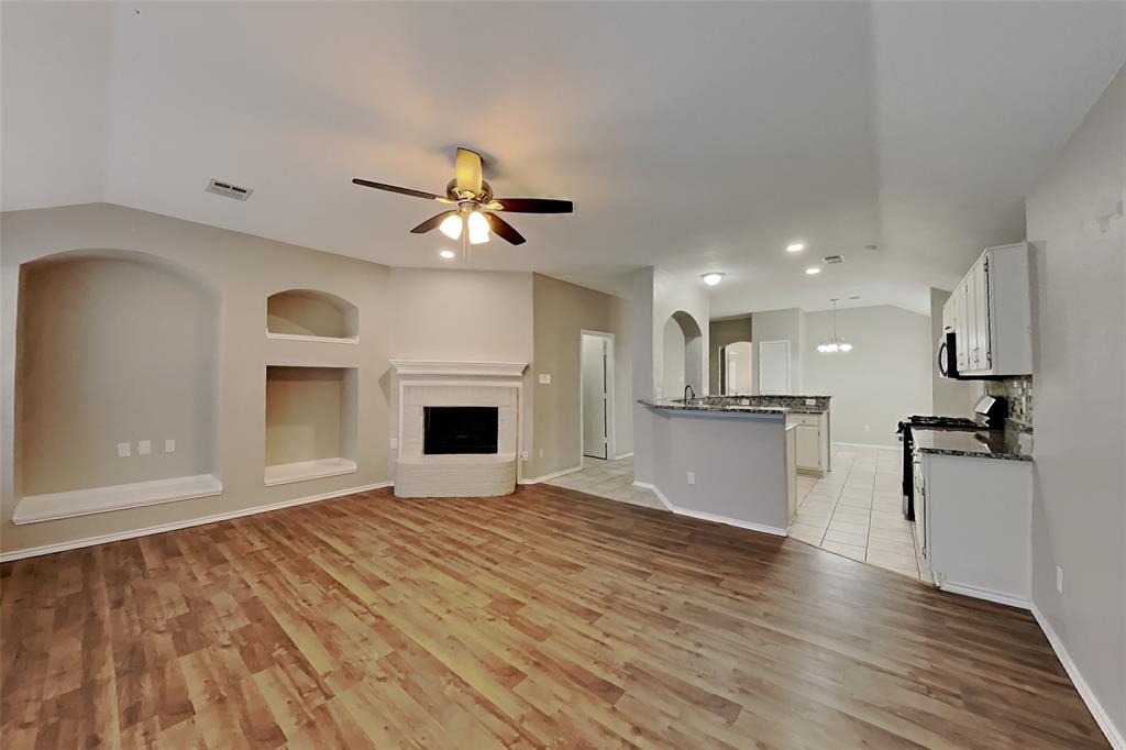 7709 Harbor Drive Rowlett, TX 75088 - Photo 2 of 19 a view of a kitchen with a sink and a refrigerator