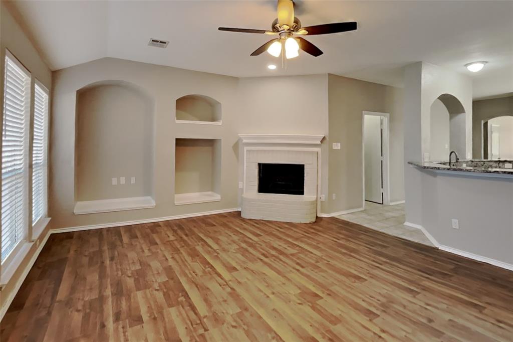 7709 Harbor Drive Rowlett, TX 75088 - Photo 3 of 19 a view of empty room with wooden floor and fan