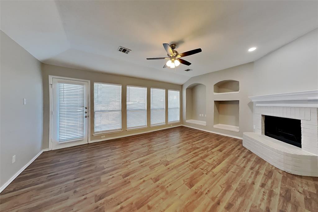 7709 Harbor Drive Rowlett, TX 75088 - Photo 4 of 19 a view of an empty room with glass door and wooden floor