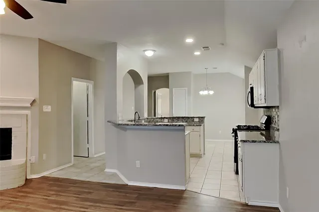 a view of a kitchen with a sink stainless steel appliances and cabinets