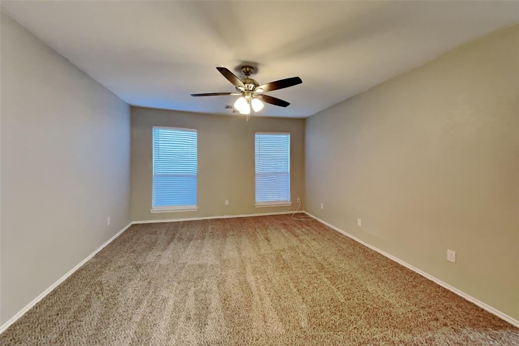 7709 Harbor Drive Rowlett, TX 75088 - Photo 8 of 19 a view of an empty room with a ceiling fan and window