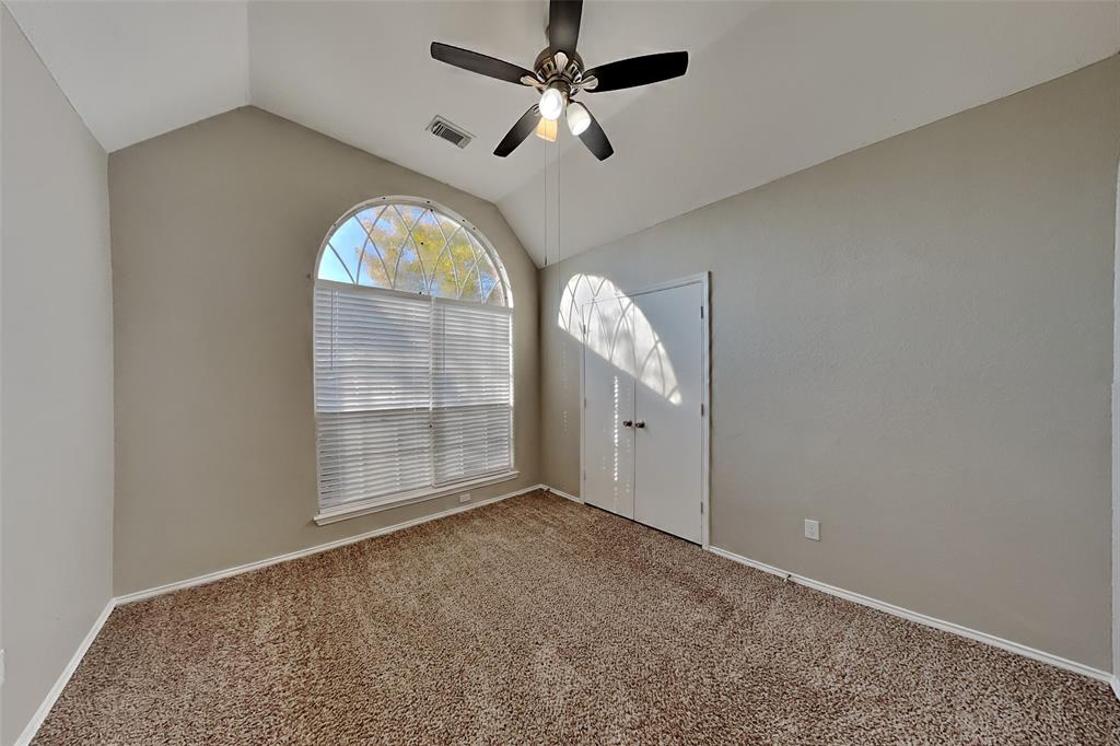 7709 Harbor Drive Rowlett, TX 75088 - Photo 10 of 19 an empty room with windows and fan