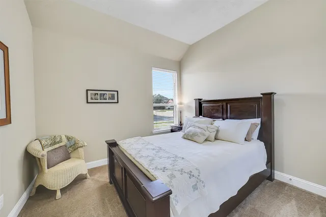 a bedroom with a bed and couch