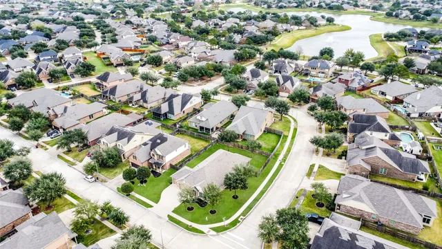 an aerial view of residential houses with outdoor space and swimming pool