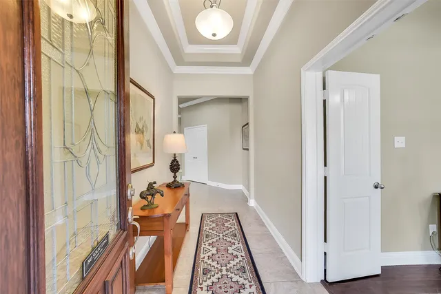 a view of a hallway with wooden floor and stairs