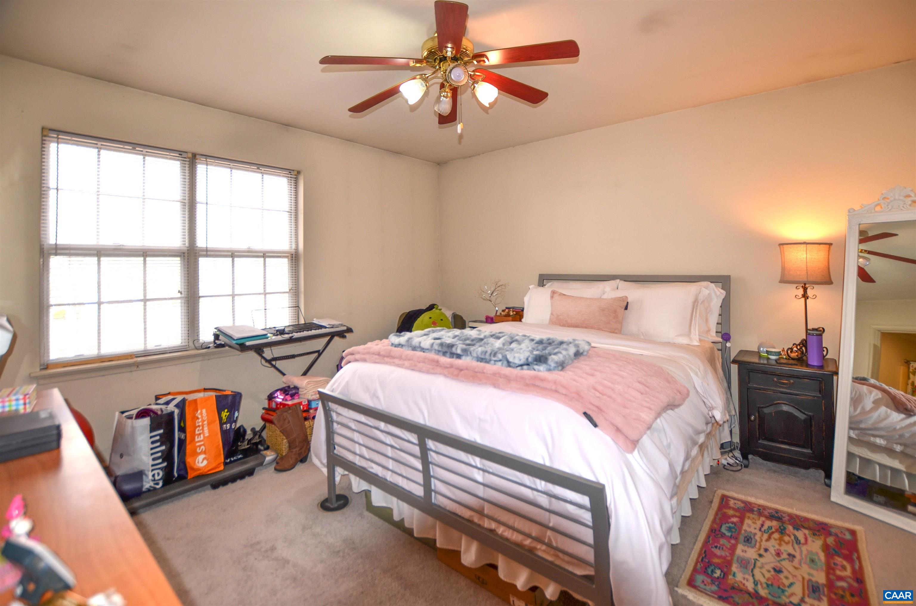 1594 Cool Spring Road Charlottesville, VA 22901 - Photo 17 of 26 a bedroom with a bed and a chandelier