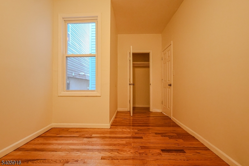 101 Hedden Terrace Newark, NJ 07108 - Photo 11 of 34 a view of an empty room with wooden floor and a window