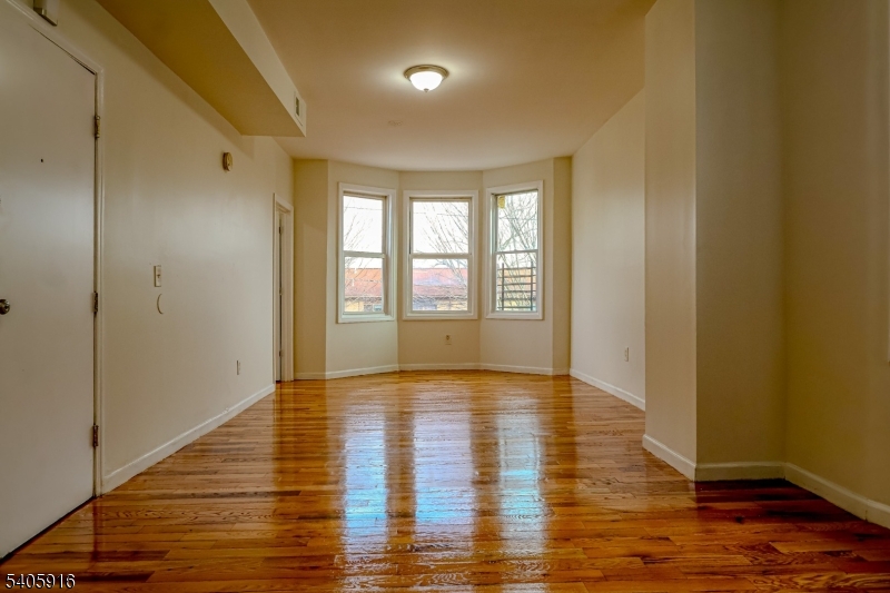 101 Hedden Terrace Newark, NJ 07108 - Photo 16 of 34 a view of an empty room with wooden floor and a window