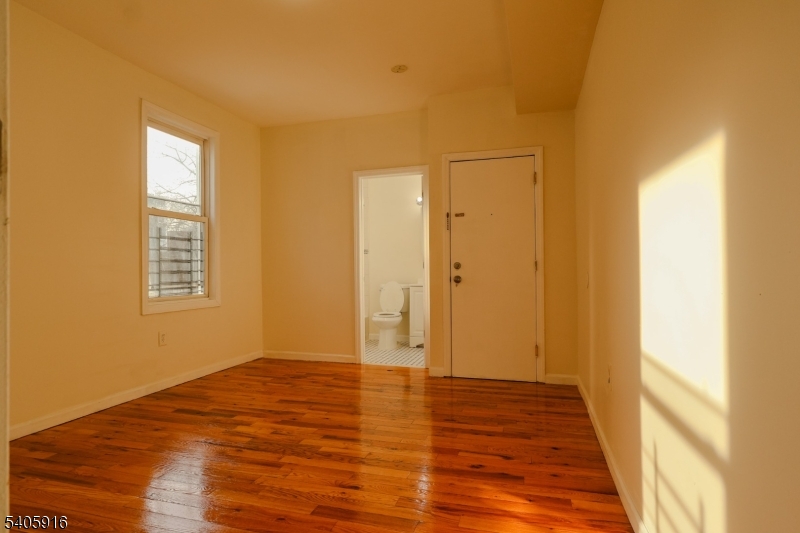 101 Hedden Terrace Newark, NJ 07108 - Photo 25 of 34 a view of an empty room with wooden floor and a window