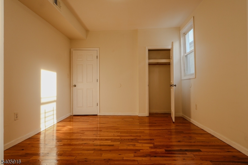 101 Hedden Terrace Newark, NJ 07108 - Photo 27 of 34 a view of an empty room with wooden floor and closet