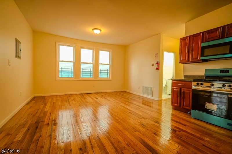 101 Hedden Terrace Newark, NJ 07108 - Photo 7 of 34 a view of a kitchen with wooden floor and electronic appliances