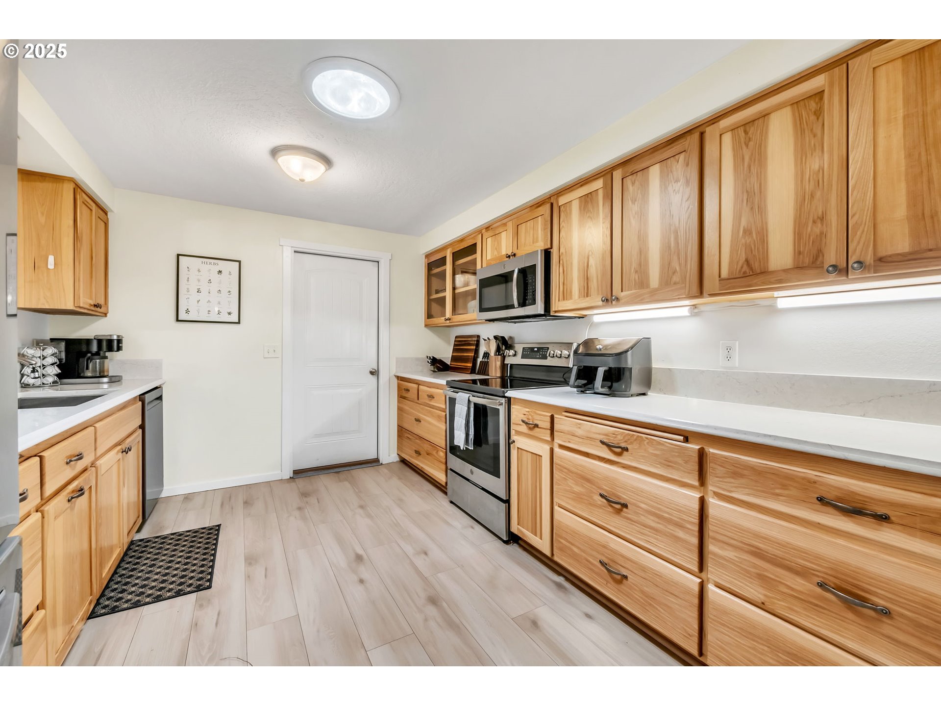 515 70th Street Springfield, OR 97478 - Photo 13 of 47 a kitchen with granite countertop a stove top oven a sink dishwasher and cabinets with wooden floor