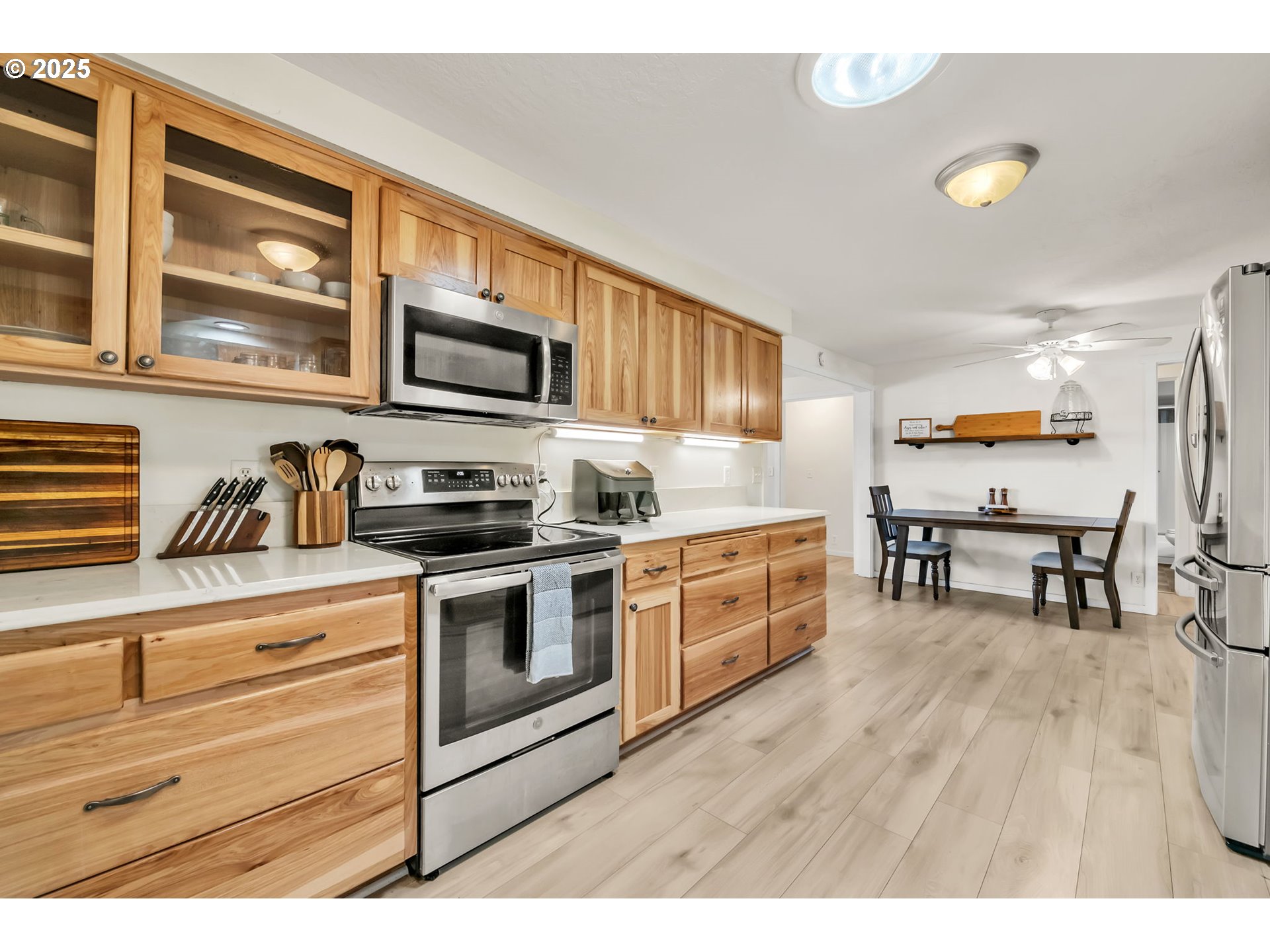 515 70th Street Springfield, OR 97478 - Photo 15 of 47 a kitchen with stainless steel appliances granite countertop a stove a sink and a microwave