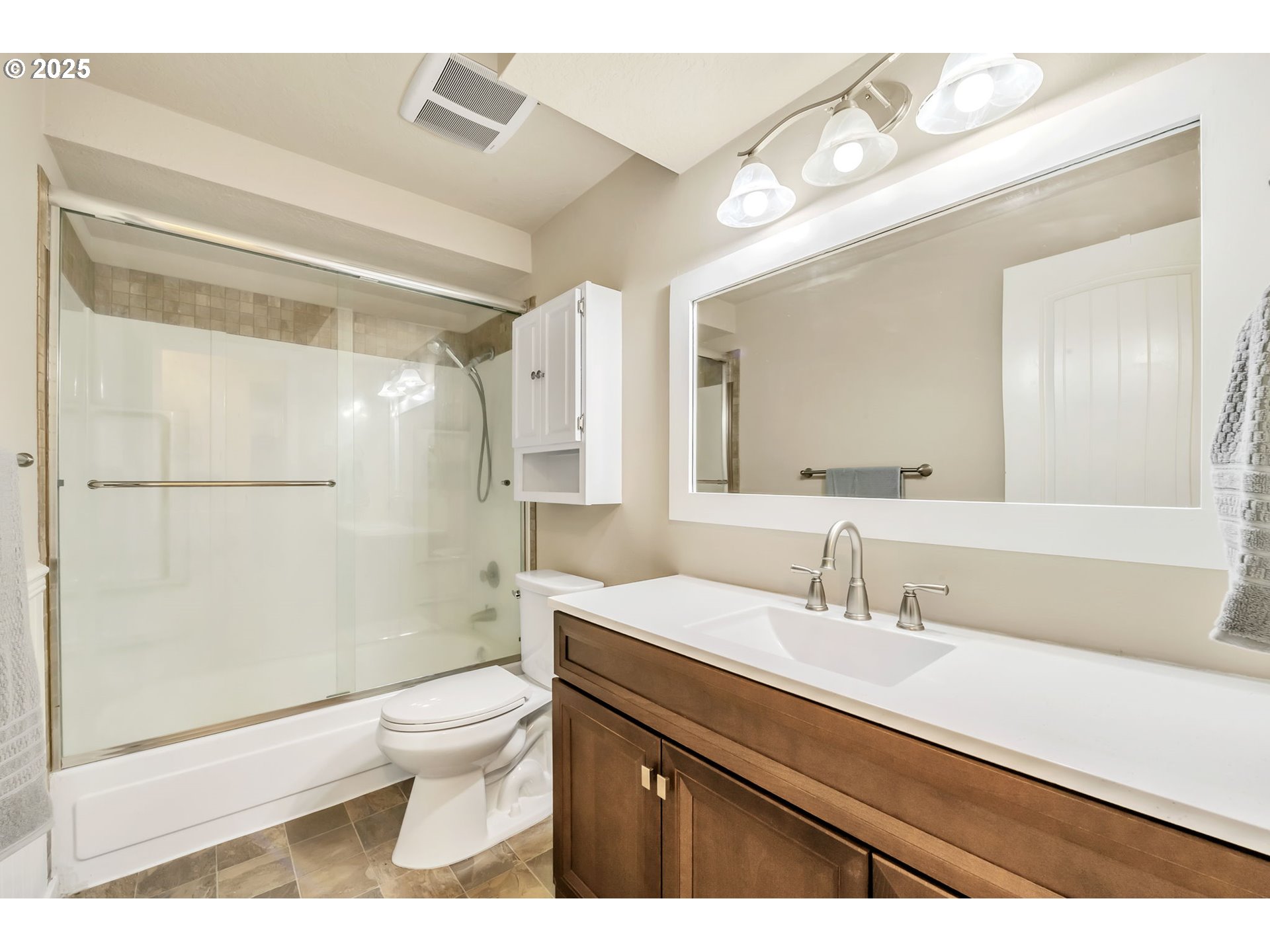 515 70th Street Springfield, OR 97478 - Photo 20 of 47 a bathroom with a sink a toilet a mirror and shower