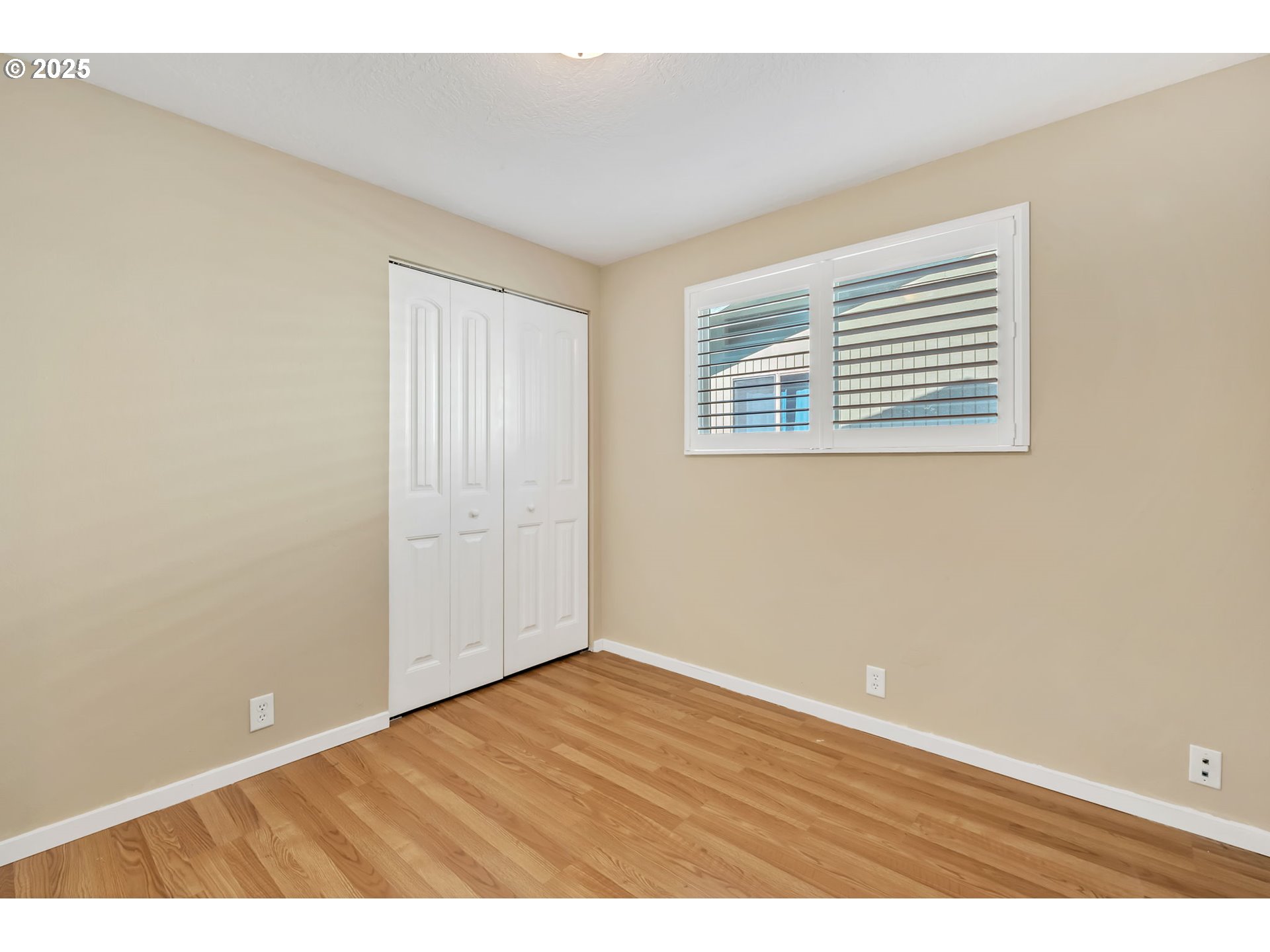 515 70th Street Springfield, OR 97478 - Photo 26 of 47 an empty room with wooden floor and windows