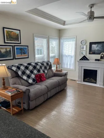 a living room with furniture a flat screen tv and a fireplace