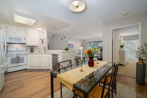 a kitchen with a refrigerator and a stove top oven