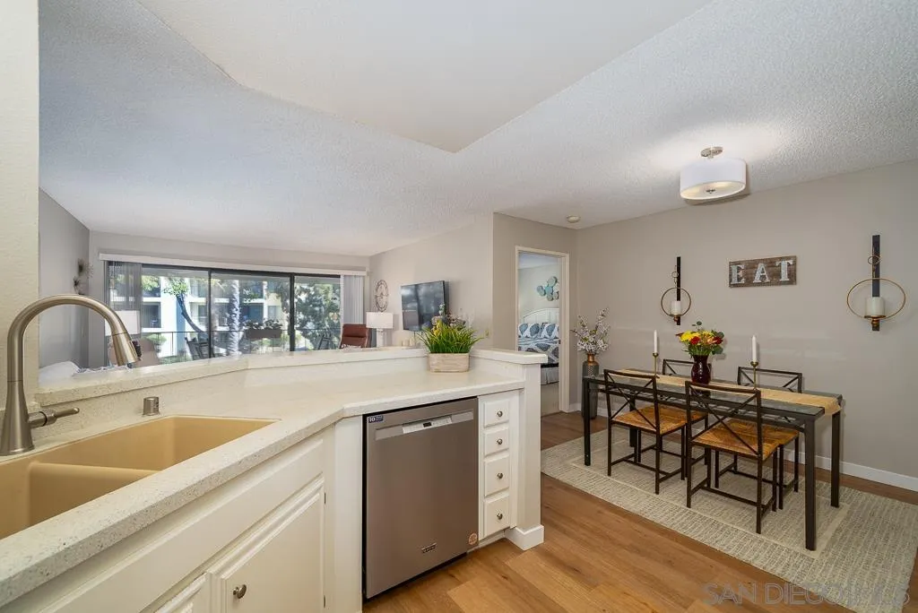 17617 Pomerado Road, Unit 215 San Diego, CA 92128 - Photo 18 of 64 a kitchen with sink cabinets and dining table