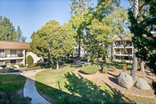 an aerial view of residential houses with outdoor space and river
