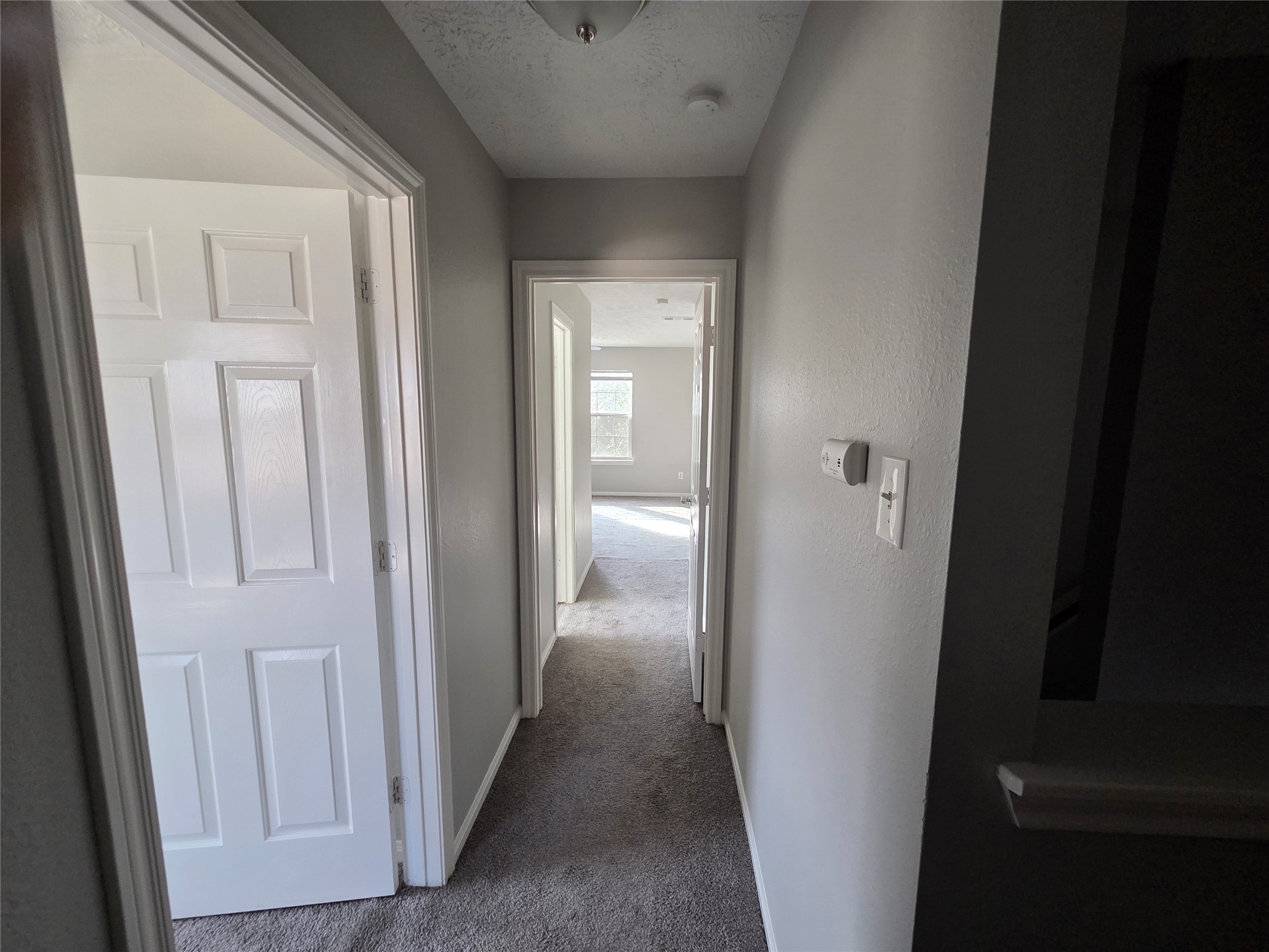 32018 Annice Lane Pinehurst, TX 77362 - Photo 11 of 19 This inviting hallway guides you towards the tranquil sanctuary of the primary suite, promising comfort and privacy.