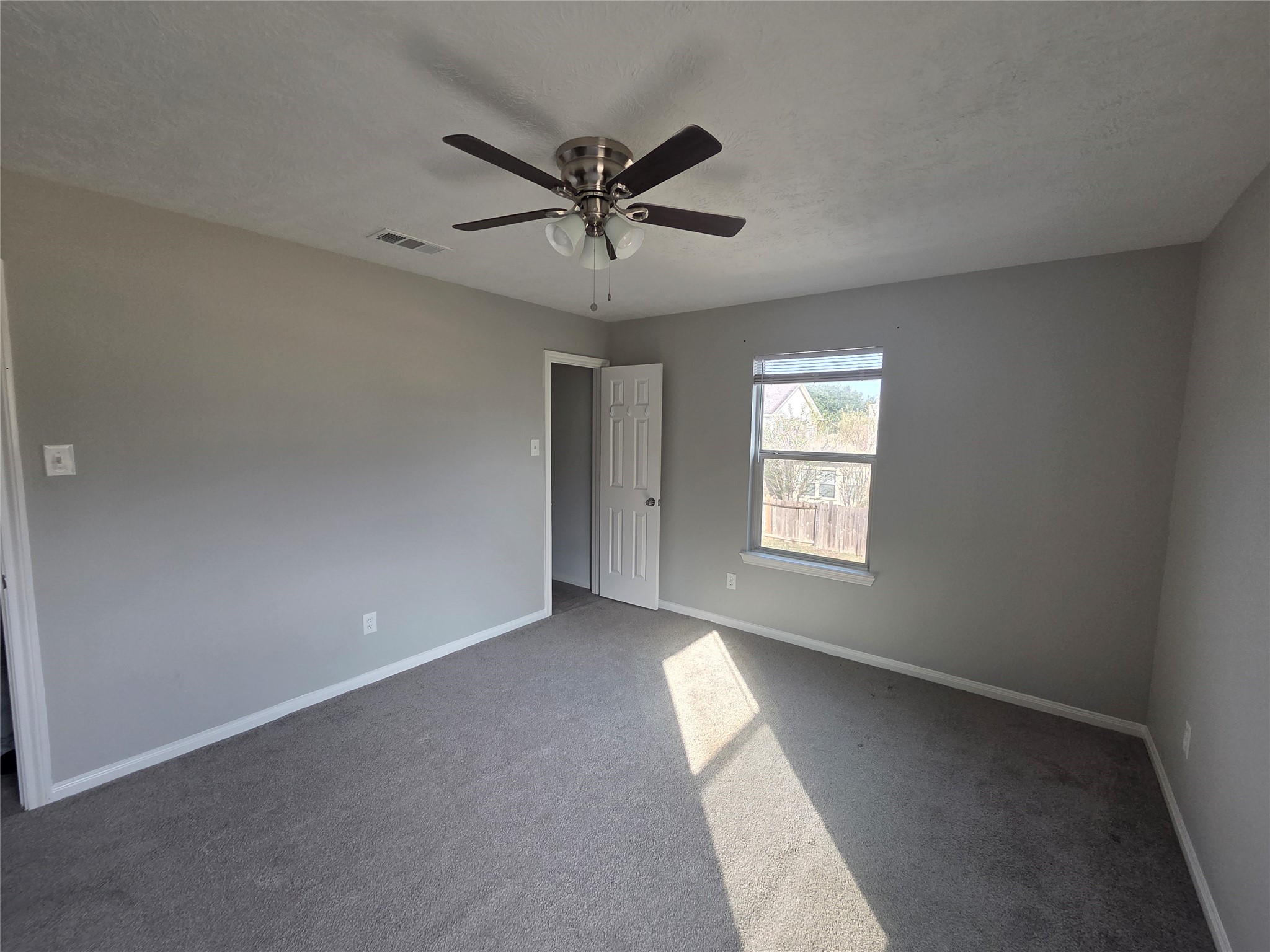 32018 Annice Lane Pinehurst, TX 77362 - Photo 14 of 19 This inviting secondary bedroom features soft carpeting, a neutral palette, and ample natural light, creating a cozy and versatile space for relaxation or productivity.