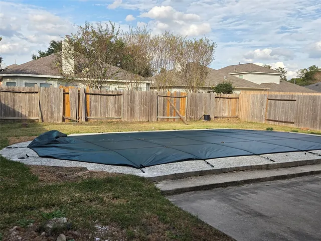 a view of small yard with large trees