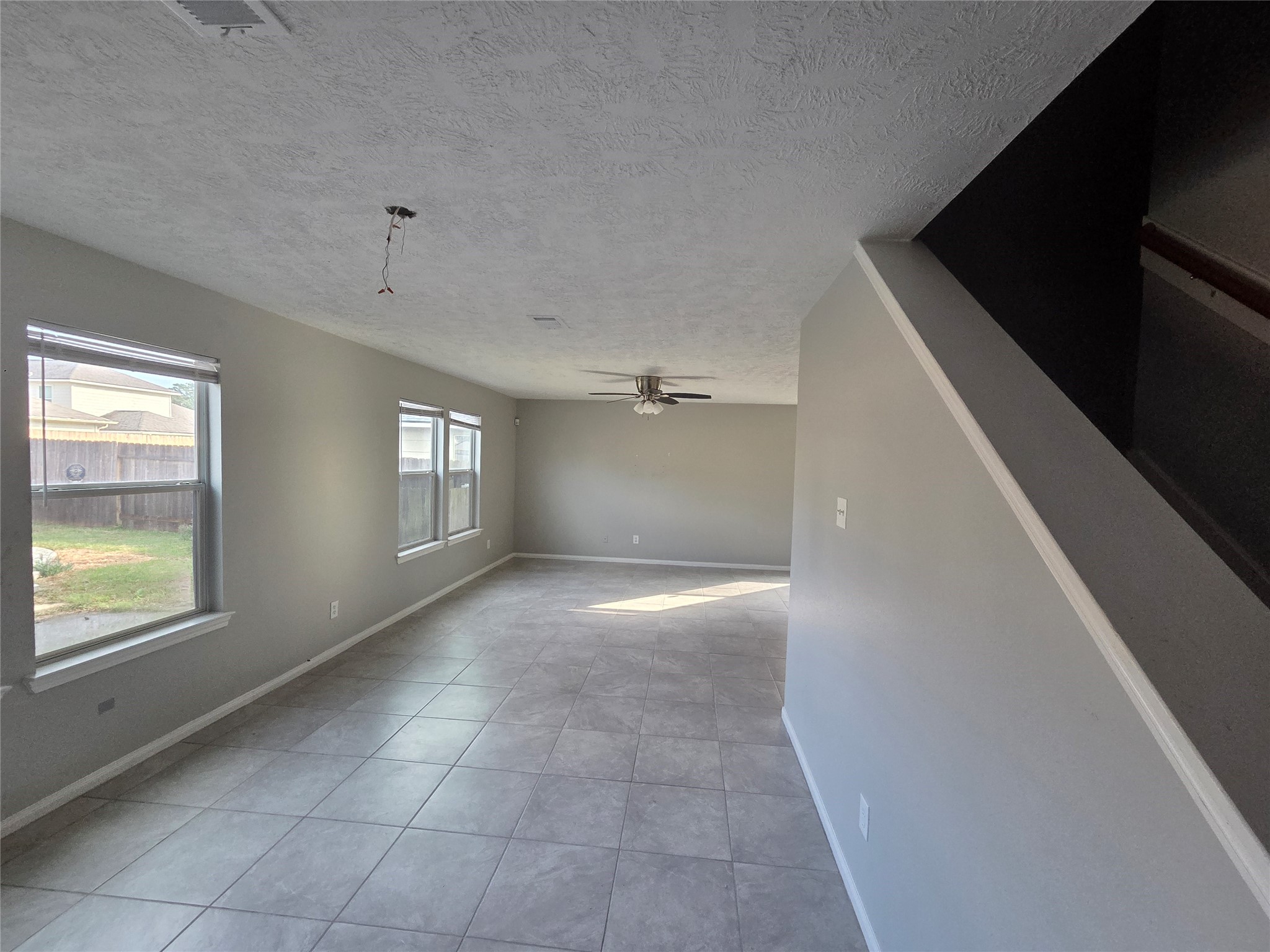 32018 Annice Lane Pinehurst, TX 77362 - Photo 3 of 19 Experience seamless indoor-outdoor living with this open kitchen flowing into a spacious living room, offering a perfect view of the backyard and pool.