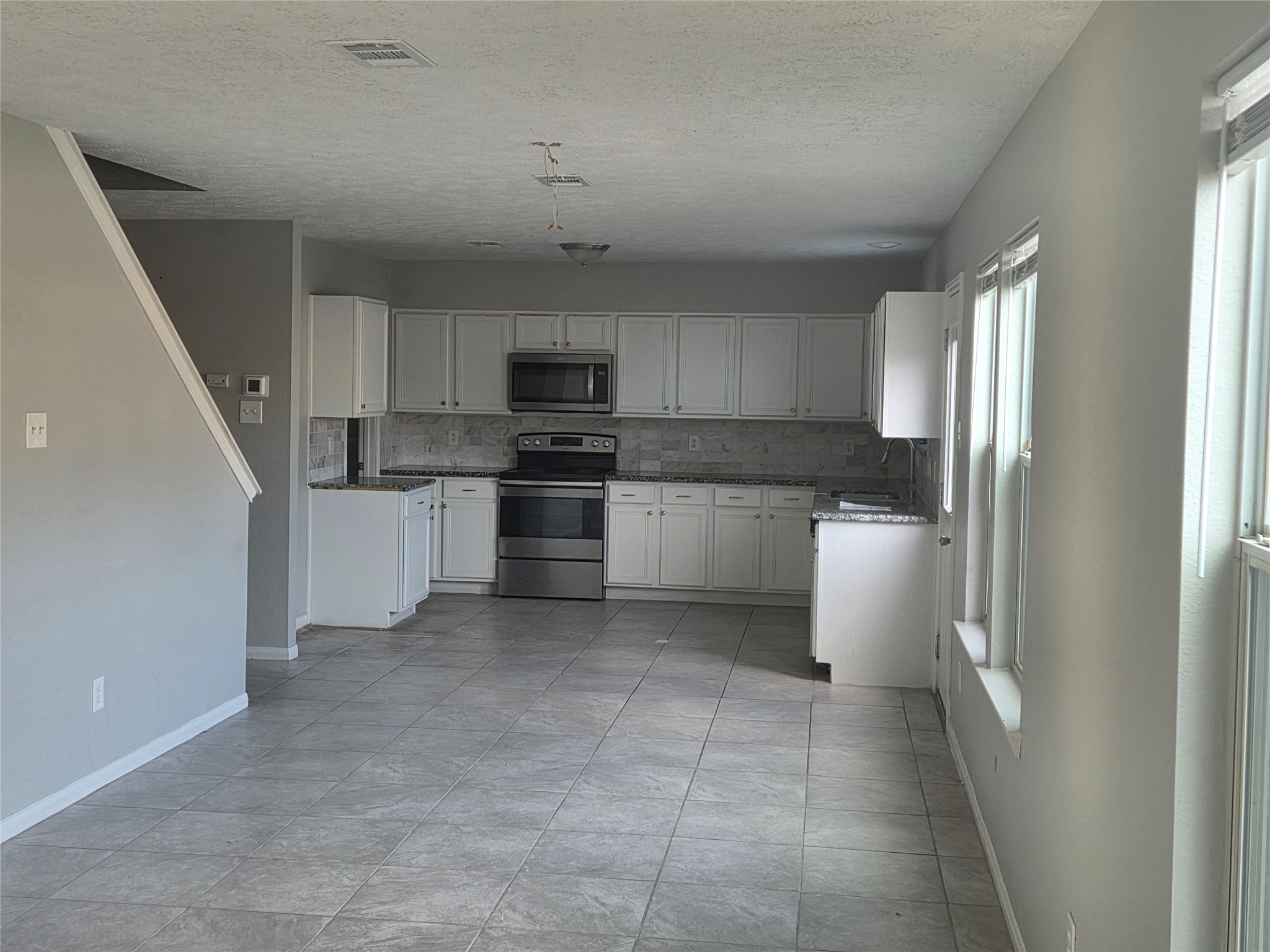 32018 Annice Lane Pinehurst, TX 77362 - Photo 6 of 19 Experience modern living in this beautifully updated kitchen, featuring sleek stainless steel appliances, elegant cabinetry, and abundant natural light.