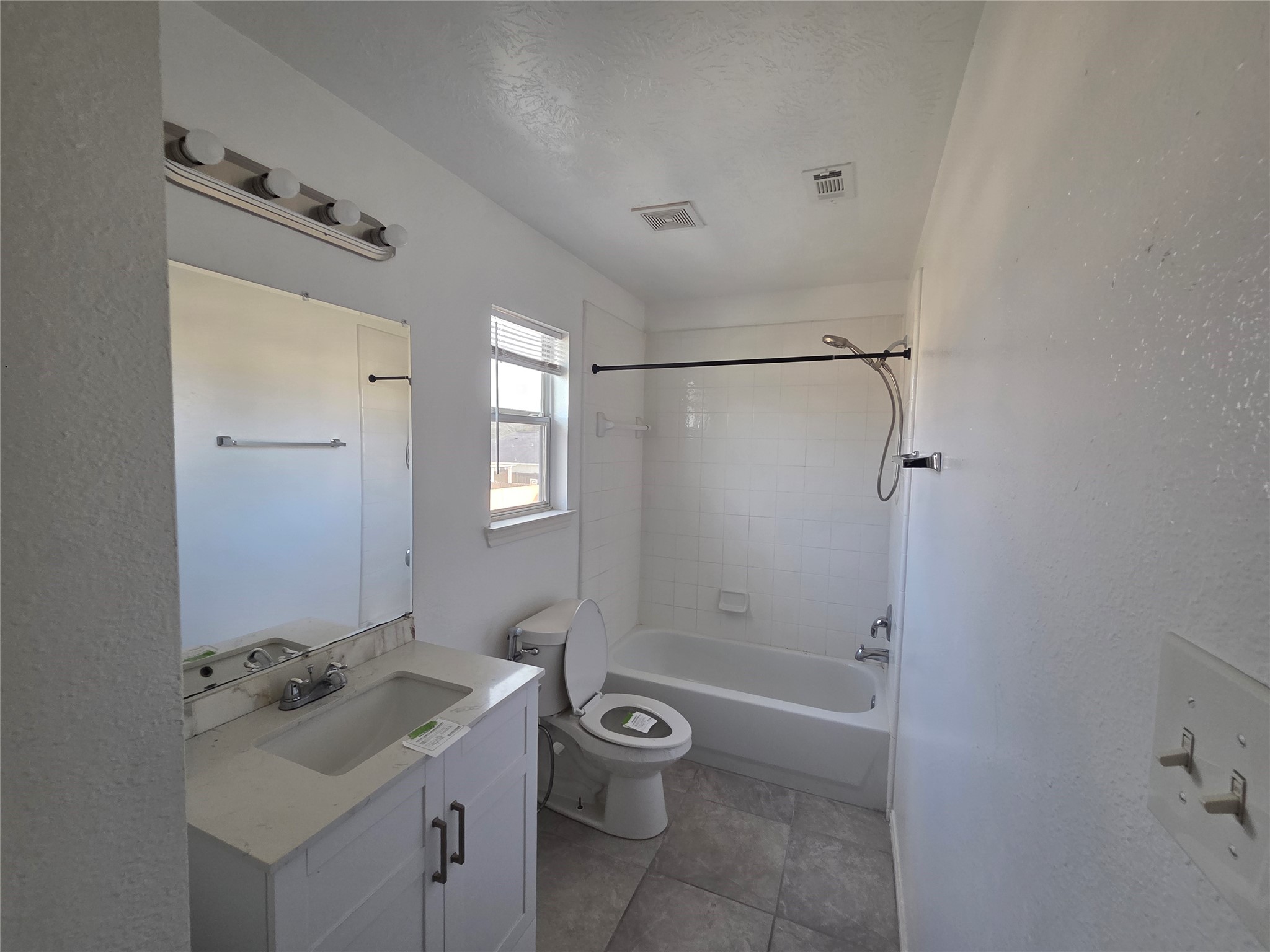 32018 Annice Lane Pinehurst, TX 77362 - Photo 9 of 19 This secondary bath offers a bright, clean space with modern fixtures, a sleek vanity, and a refreshing tub-shower combo, perfect for comfort and convenience.