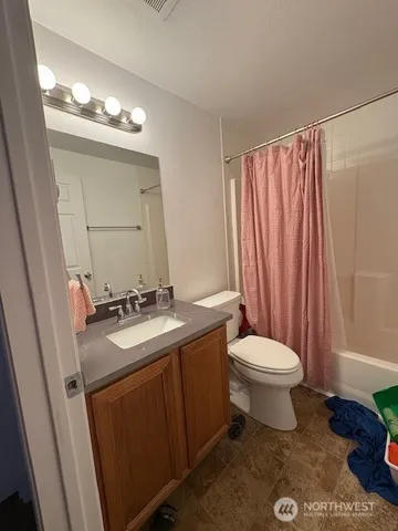 a bathroom with a sink a toilet and mirror