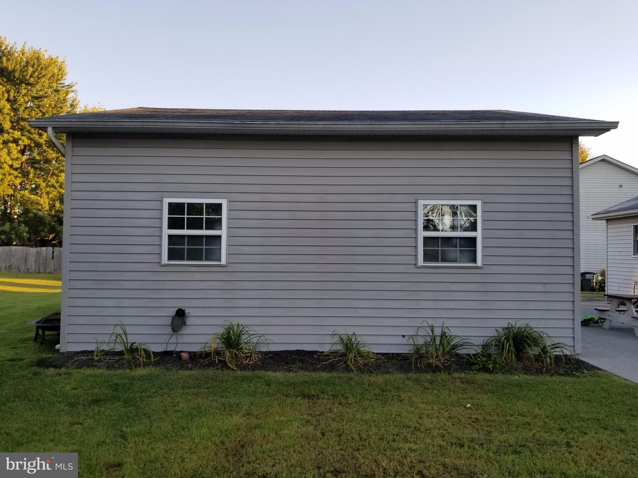 307 Raven Road Stephens City, VA 22655 - Photo 4 of 8 a front view of a house with a garden