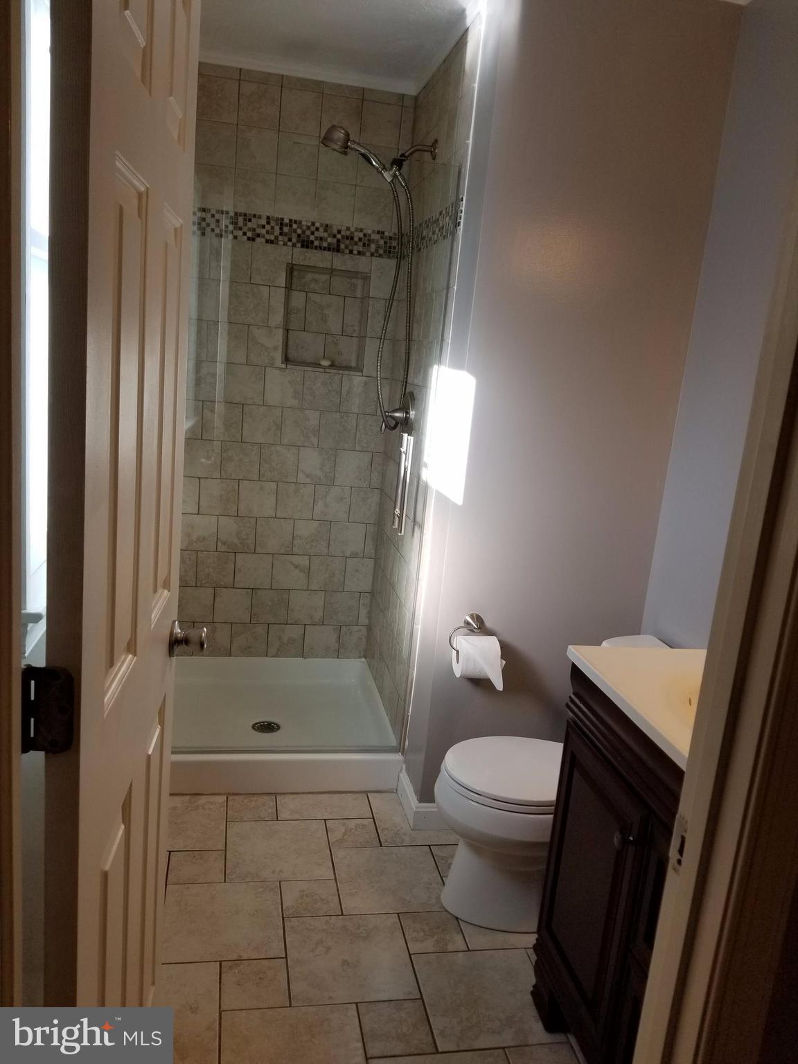 307 Raven Road Stephens City, VA 22655 - Photo 7 of 8 a bathroom with a granite countertop bathtub shower and toilet