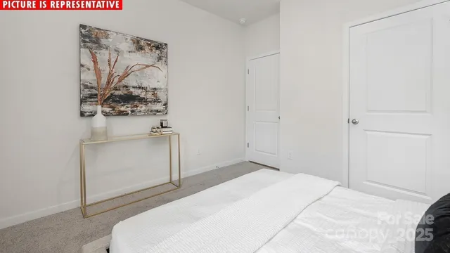 a bedroom with a bed and a white cabinet