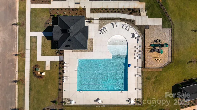 a swimming pool with outdoor seating and yard