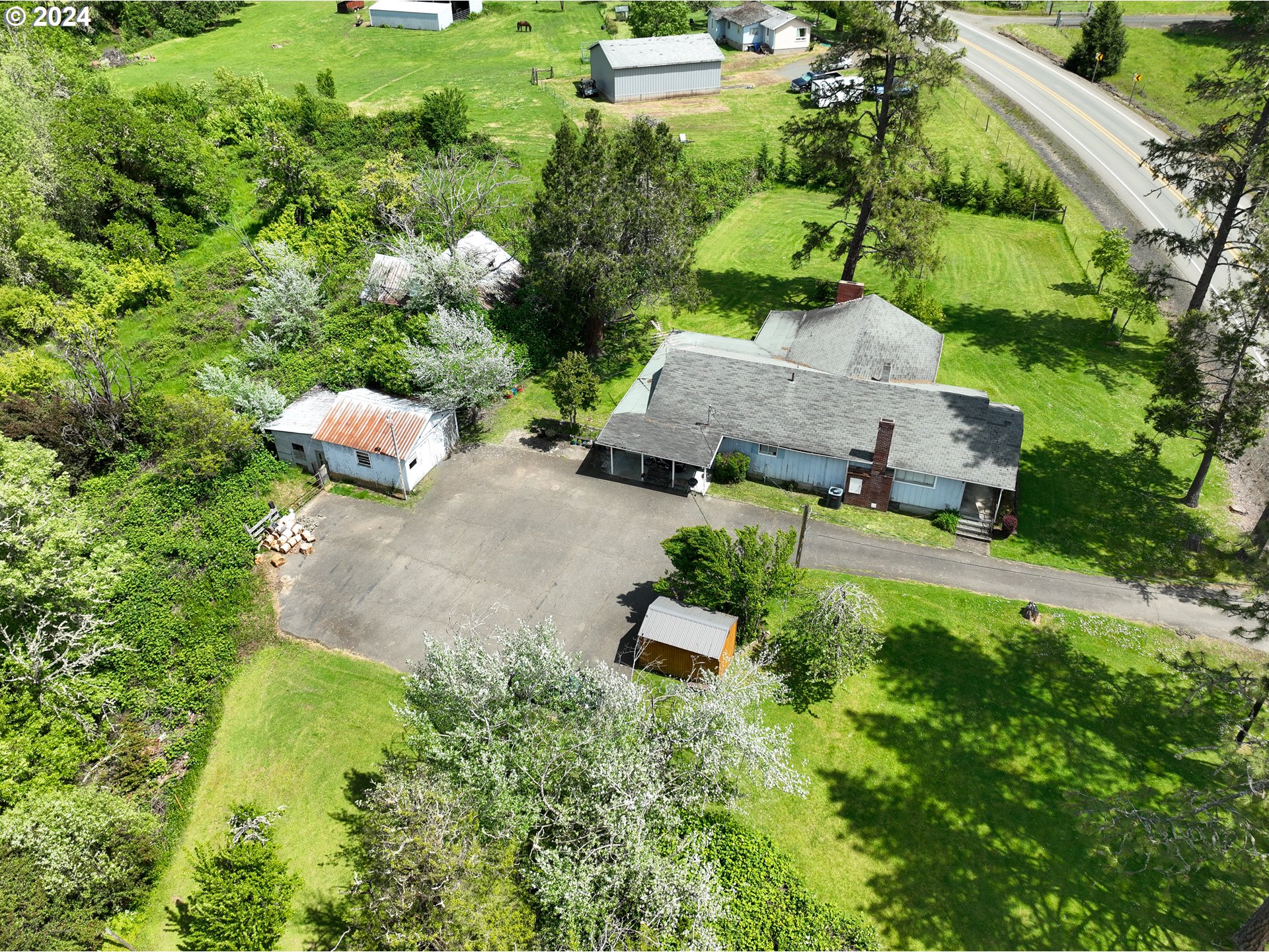 5961 Lookingglass Road Roseburg, OR 97471 - Photo 21 of 40 an aerial view of a house with a yard
