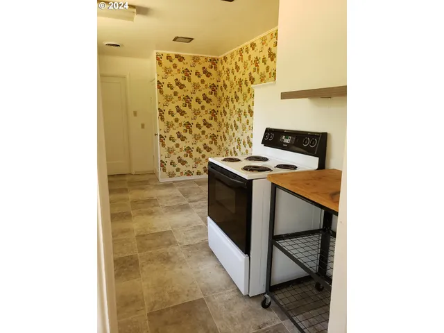 a kitchen with stainless steel appliances a sink and refrigerator