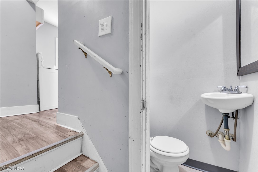 1858 Rudwick Road Cleveland, OH 44112 - Photo 27 of 36 Bathroom featuring toilet and wood finished floors