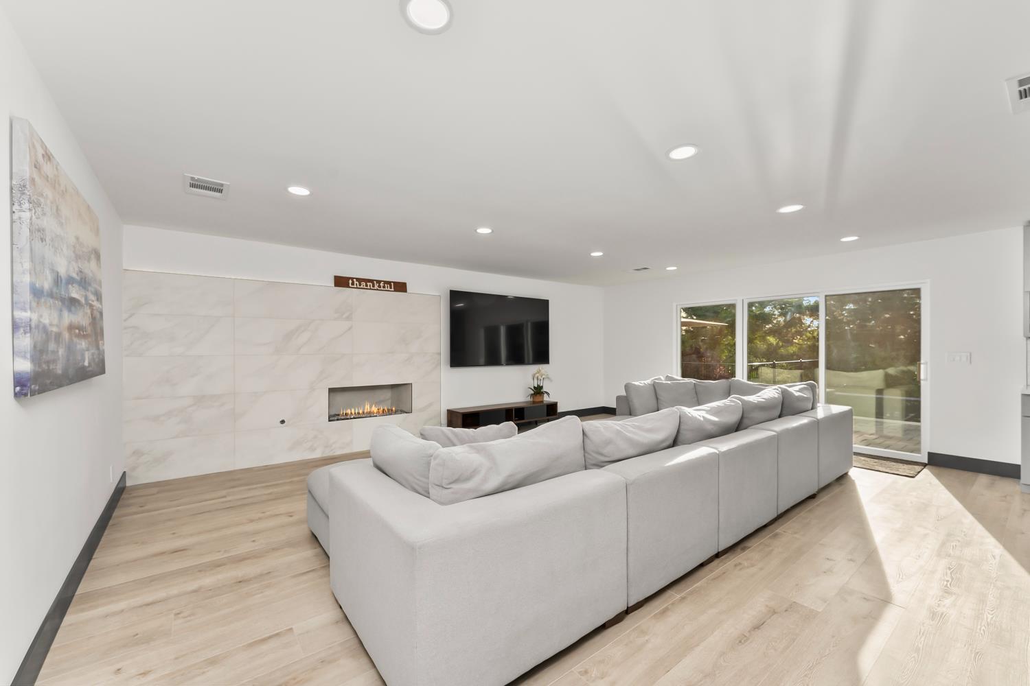 6762 Highland Road Granite Bay, CA 95746 - Photo 27 of 90 a living room with furniture and a flat screen tv