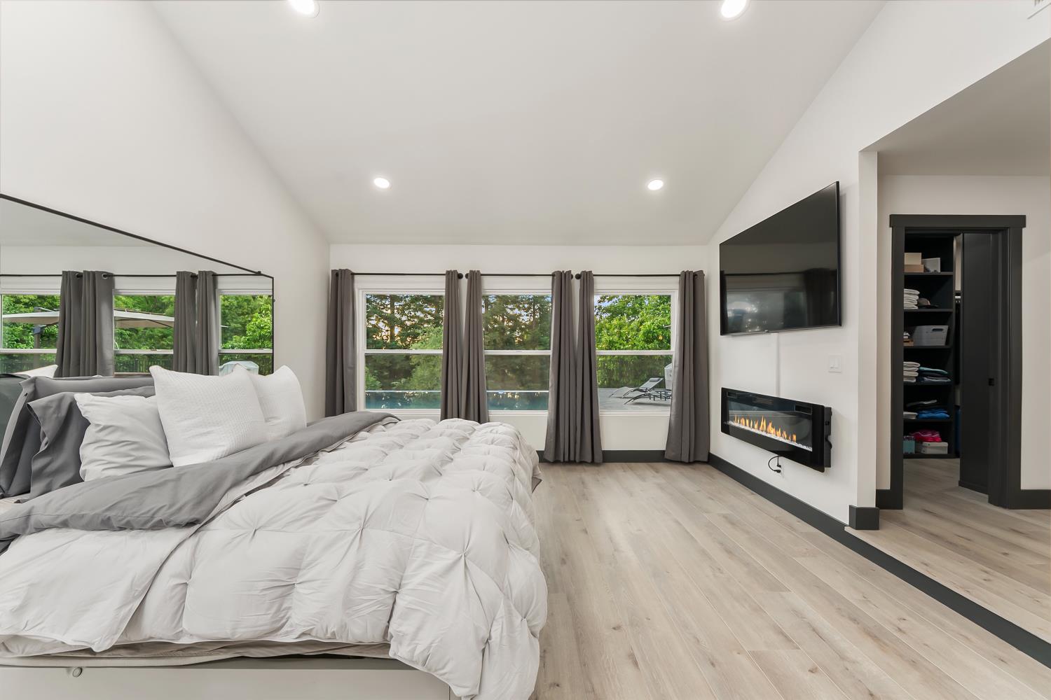 6762 Highland Road Granite Bay, CA 95746 - Photo 36 of 90 a spacious bedroom with a balcony a bed and a flat screen tv