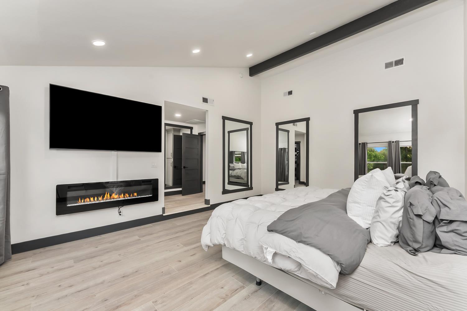 6762 Highland Road Granite Bay, CA 95746 - Photo 38 of 90 a spacious bedroom with a bed and a flat screen tv
