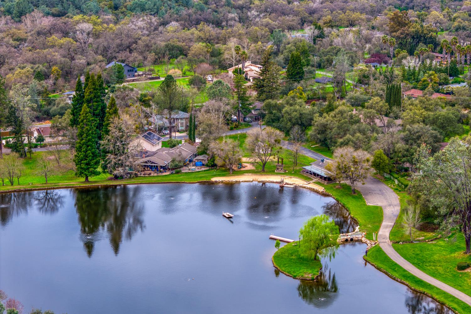 6762 Highland Road Granite Bay, CA 95746 - Photo 78 of 90 an aerial view of a houses with a yard and lake