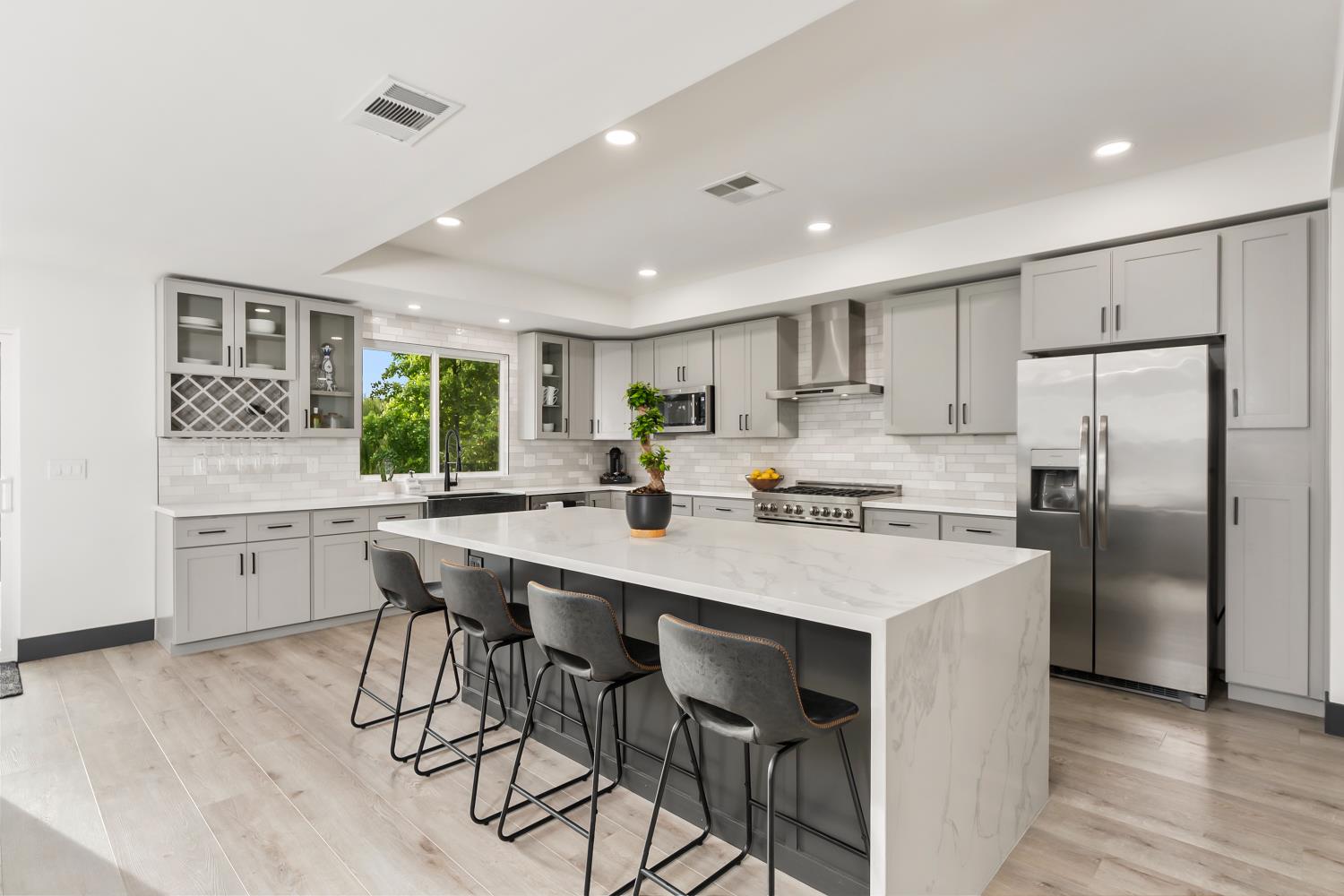 6762 Highland Road Granite Bay, CA 95746 - Photo 8 of 90 a kitchen with stainless steel appliances a table chairs refrigerator and cabinets