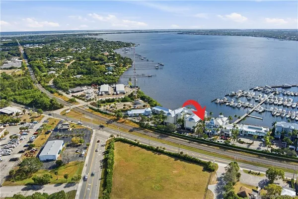 an aerial view of a residential houses with outdoor space lake view and ocean view
