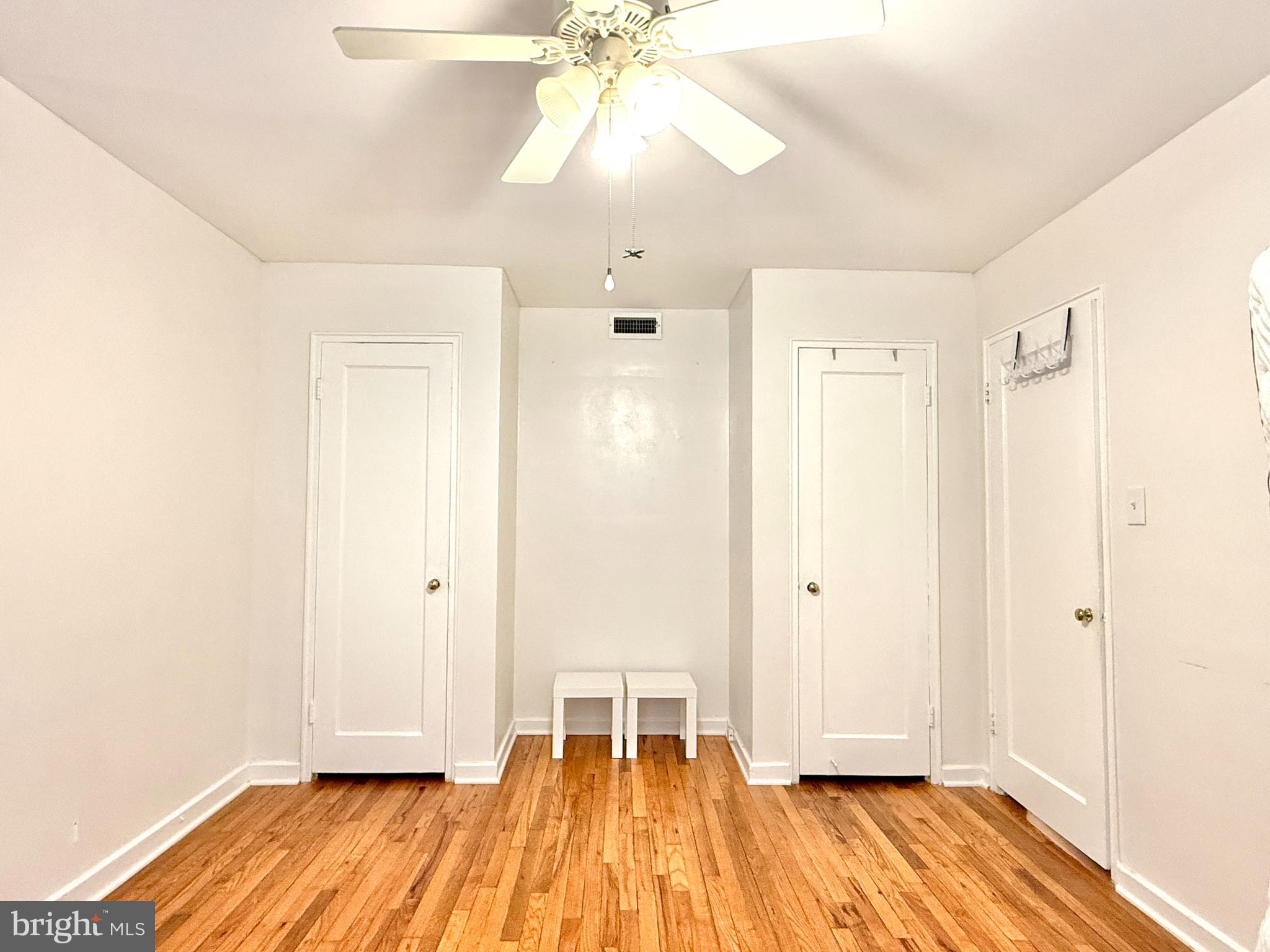 2205 Washington Avenue, Unit 102 Silver Spring, MD 20910 - Photo 14 of 20 a view of a room with wooden floor and white walls