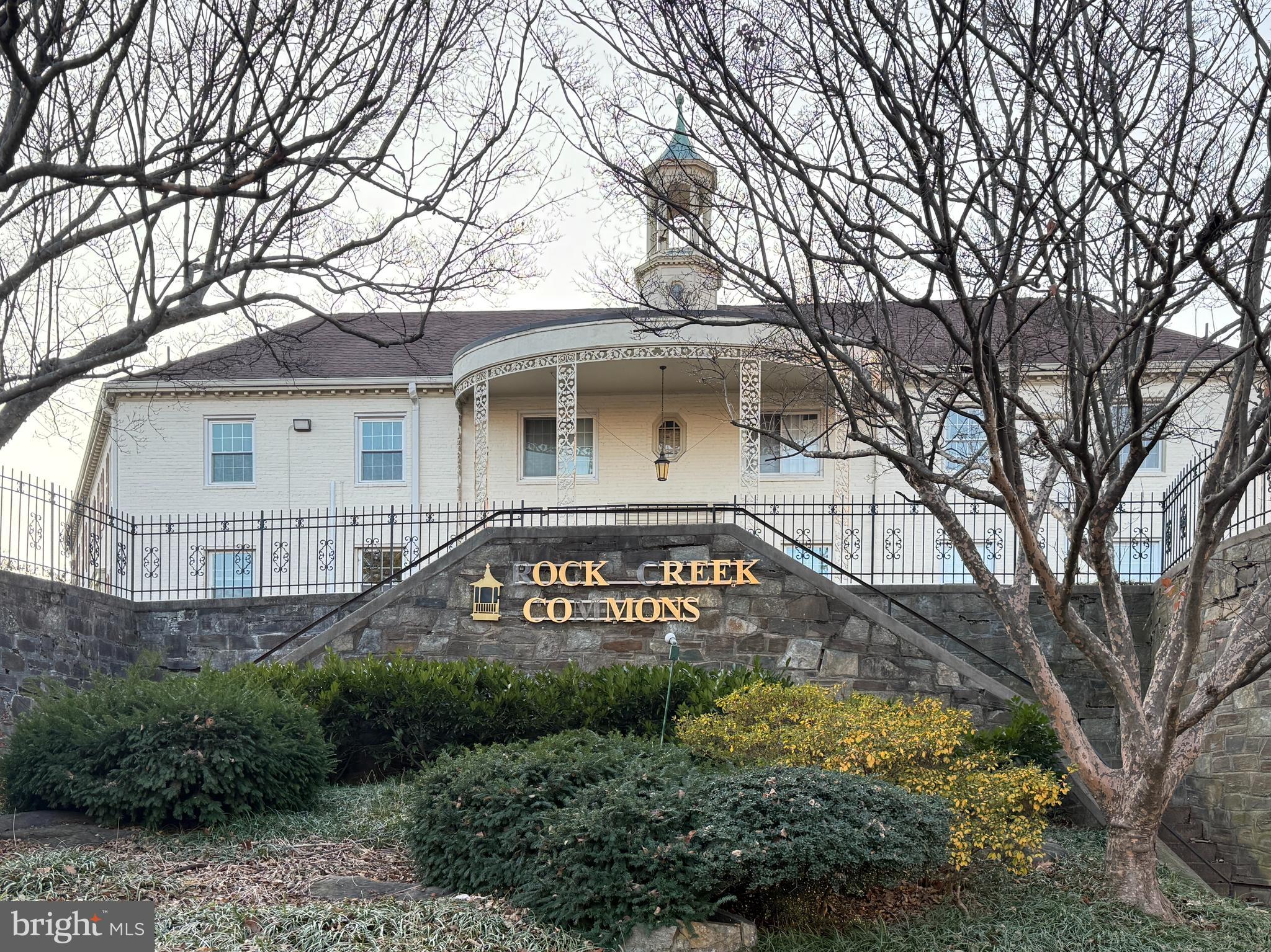 2205 Washington Avenue, Unit 102 Silver Spring, MD 20910 - Photo 2 of 20 a view of a white house with a large tree next to a yard