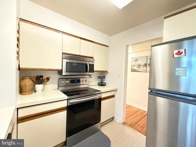 a kitchen with stainless steel appliances a refrigerator sink and cabinets