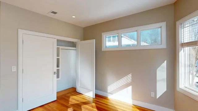 a view of a room with wooden floor and bedroom