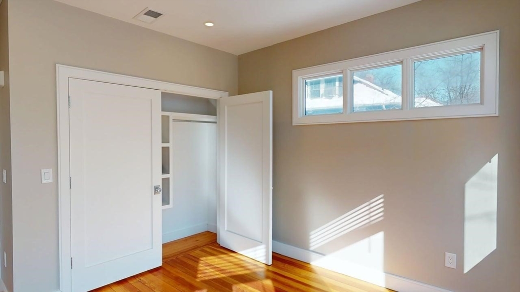179 Appleton Street, Unit 2 Cambridge, MA 02138 - Photo 15 of 23 a view of a room with wooden floor and bedroom
