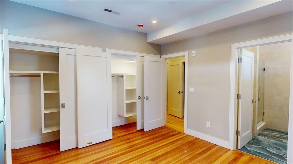 179 Appleton Street, Unit 2 Cambridge, MA 02138 - Photo 19 of 23 a view of empty room with wooden floor